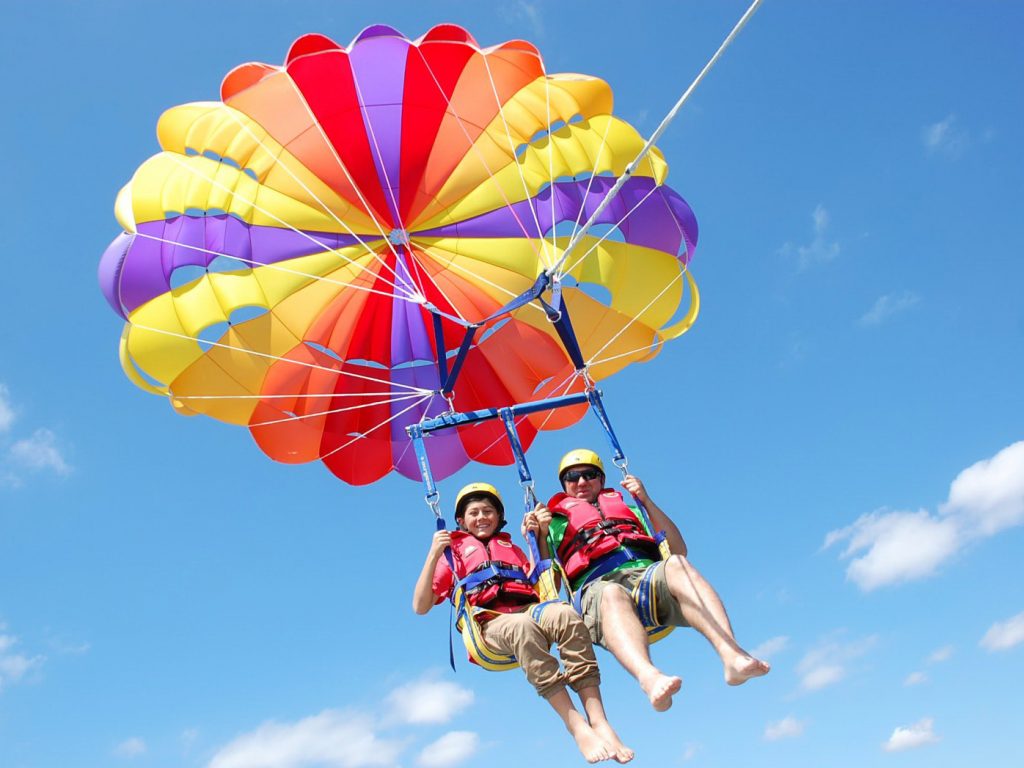 Fly high above the ocean as you go Parasailing